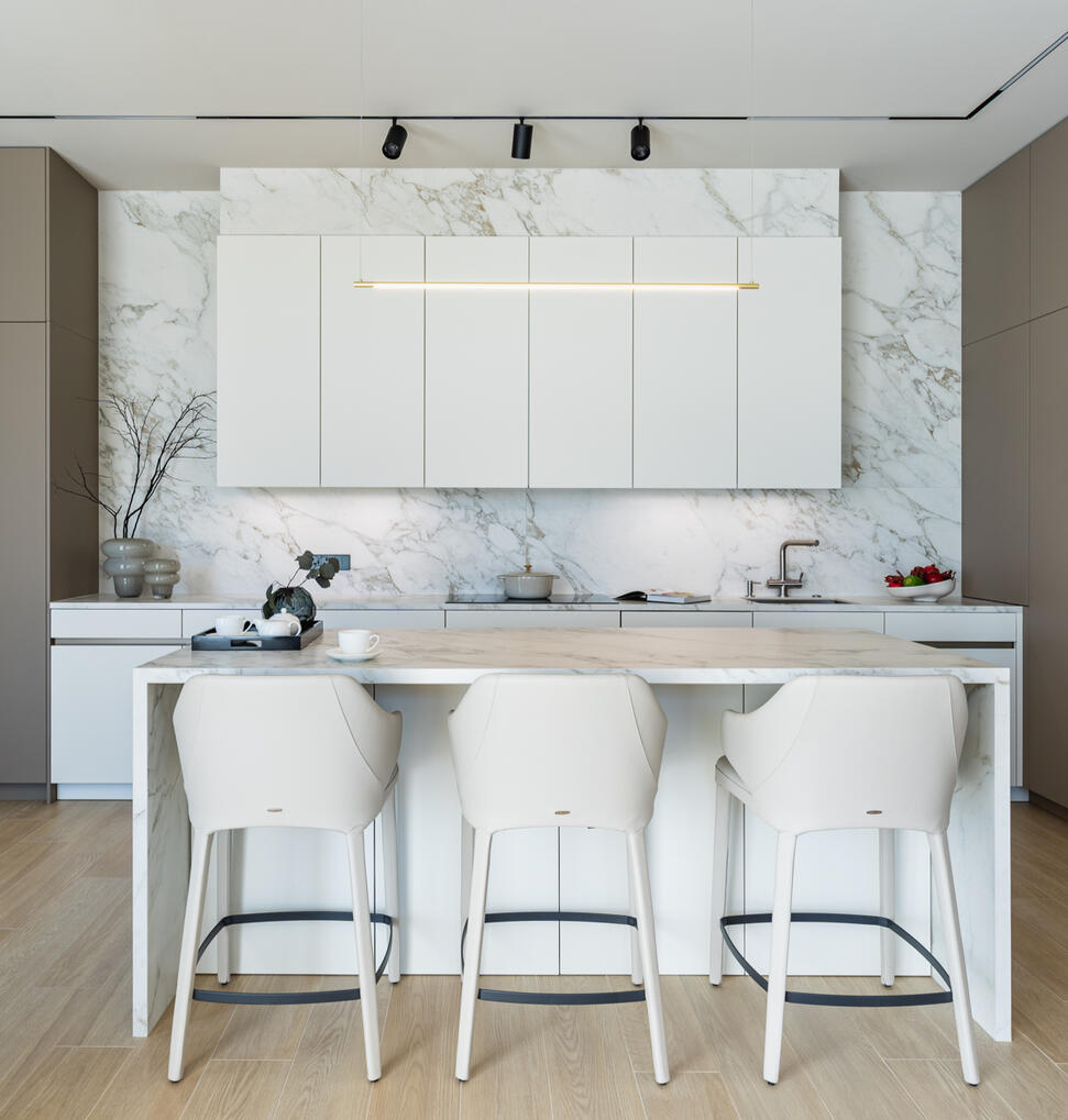 Minimalist White Kitchen in Cyprus Interior photography of a modern white kitchen with a minimalist design, natural materials and clean architectural lines.