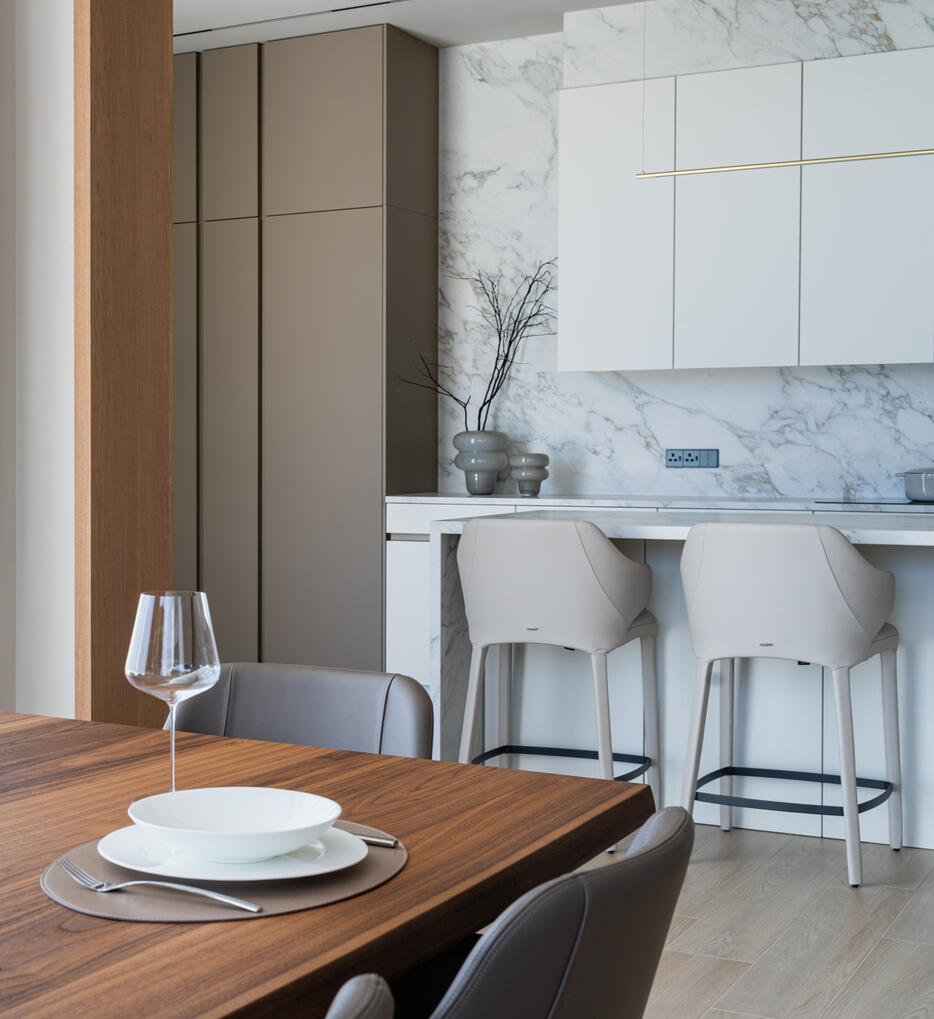 Open-Plan Dining and Kitchen Interior Interior photography of an open-plan dining and kitchen area, showcasing the connection between the spaces, natural tones and warm wood details.