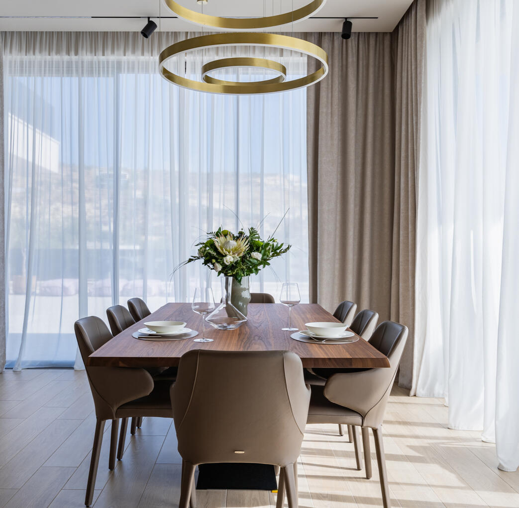 Modern Dining Area in a Private Home Interior photography of a spacious dining area in a contemporary private home, featuring natural tones, clean lines and abundant natural light.